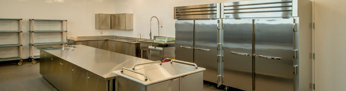 A restaurant kitchen containing commercial refrigeration equipment